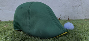 The Master Scally Cap has been restocked! Photo shows Master Cap sitting on grass next to golf ball