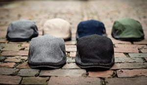 The Legacy Boston Scally Caps sitting on a Brick Road