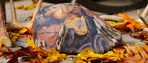 Mossy Oak Cap on Leafy Background