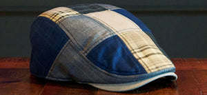 The blue patchwork single panel Dad cap sitting on a wood table