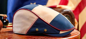 The 250th Anniversary Cap in front of an American Flag