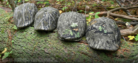 Mossy Oak Scally Caps on a Log