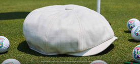 The Caddyshack Boston Scally Cap on a grass surface